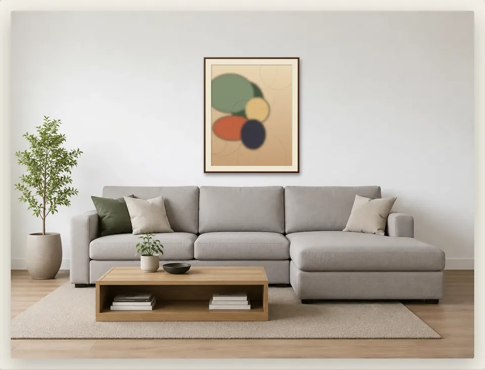 An abstract print in a walnut frame with an ivory mat, shown mounted at true scale on a bright living-room wall in Framed.